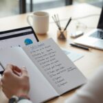 Someone with an SEO checklist next to their laptop